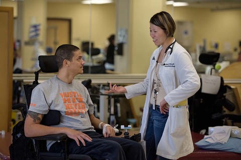 Dr. Anna Choo Elmers with spinal cord injury patient